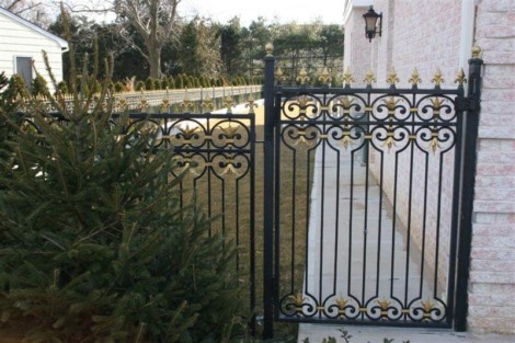 Ornamental black iron fence with gold finials enhances outdoor security and aesthetic appeal. Elegant black iron fence with gold accents for outdoor security and style.