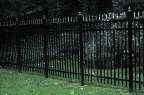 Durable black metal fencing installed for privacy and security in Long Island outdoor spaces. Black metal fence with decorative finials on Long Island property.