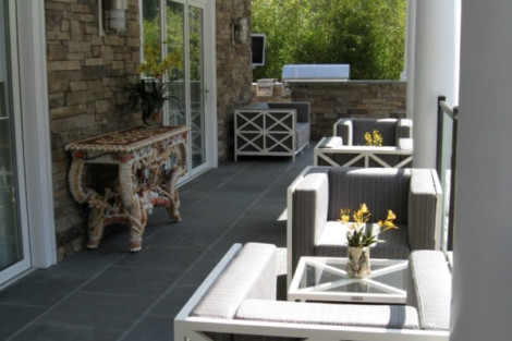 Stylish outdoor furniture arrangement on a Long Island patio, perfect for outdoor living and entertaining. Elegant outdoor furniture setup with seating and decor on a covered patio.