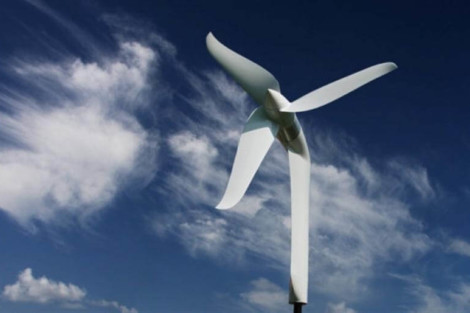 A wind turbine harnesses wind power to produce renewable energy on a clear day. Large wind turbine generating clean energy under a blue sky.