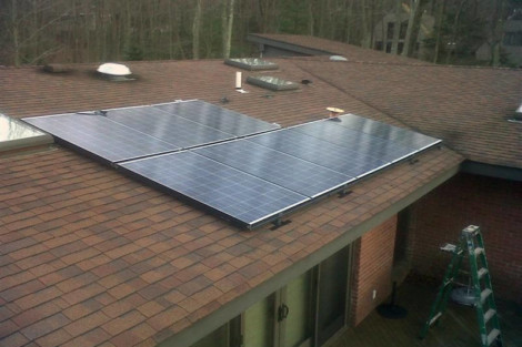 Residential roof with solar panels installed to harness solar energy for eco-friendly power. Solar panels installed on a residential roof for renewable energy.