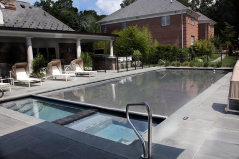 Luxury inground pool with automatic cover, outdoor seating, and landscaped backyard in Long Island. Inground pool with automatic cover and outdoor furnishings in Long Island.