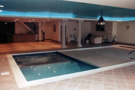 Indoor pool with automatic cover, perfect for year-round use and luxury living in Long Island. Indoor pool with automatic cover and modern decor in Long Island.