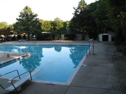 Beautiful inground pool with outdoor furnishings in Long Island, perfect for outdoor living and relaxation. Inground pool with surrounding deck and outdoor furnishings in Long Island.