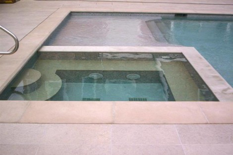 Luxury inground pool with hot tub and outdoor lounge area in Long Island, perfect for relaxation and entertainment. Long Island inground pool with attached hot tub and outdoor seating area.