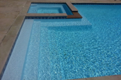 Luxury inground pool with spa and outdoor furniture, perfect for outdoor living in Long Island. Beautiful inground pool with spa and outdoor furnishings in Long Island.
