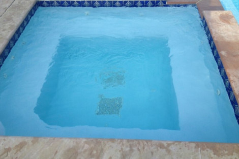 Custom inground pool installed by All Island Group in Long Island, featuring elegant stone accents and pristine water. Beautiful inground pool with clear blue water and stone border in Long Island.