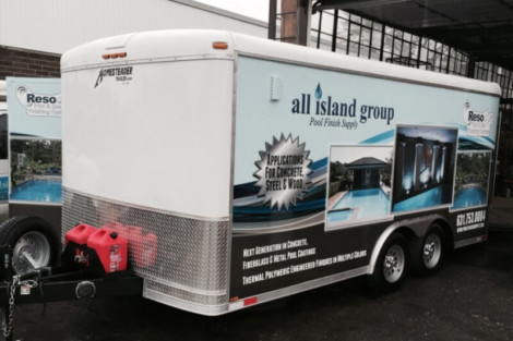 All Island Group pool supply trailer parked at a facility, ready for pool installation and outdoor furnishings services. Pool supply trailer for inground pool installation and outdoor furnishings.