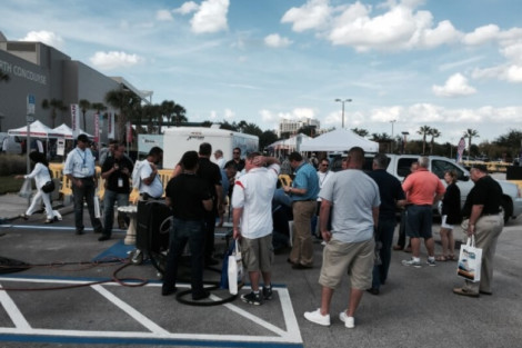 Attendees explore pool installation and outdoor furnishings at the All Island Group event in Long Island. People gather around pool equipment at outdoor event in Long Island.