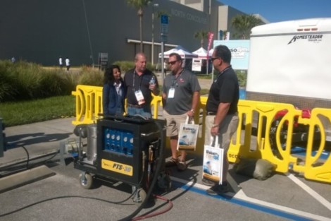 Outdoor pool equipment demonstration by All Island Group at a Long Island event, showcasing pool installation and outdoor furnishings. Group of people discussing pool equipment at outdoor event in Long Island.