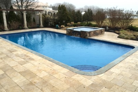 Elegant inground pool with hot tub and outdoor seating area in Long Island, perfect for outdoor living and relaxation. Beautiful inground pool with hot tub and outdoor furnishings in Long Island.