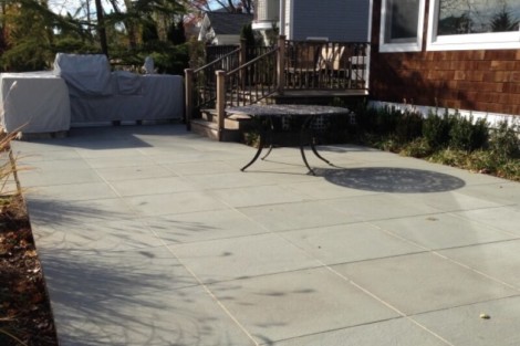 Beautiful concrete patio with outdoor furniture and deck in Long Island, perfect for outdoor living and entertaining. Concrete patio with outdoor furniture and deck in Long Island.