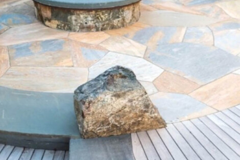 Elegant outdoor pool area with fire pit, stone and wood patio, perfect for outdoor living on Long Island. Beautiful outdoor pool area with fire pit and stone patio on Long Island.